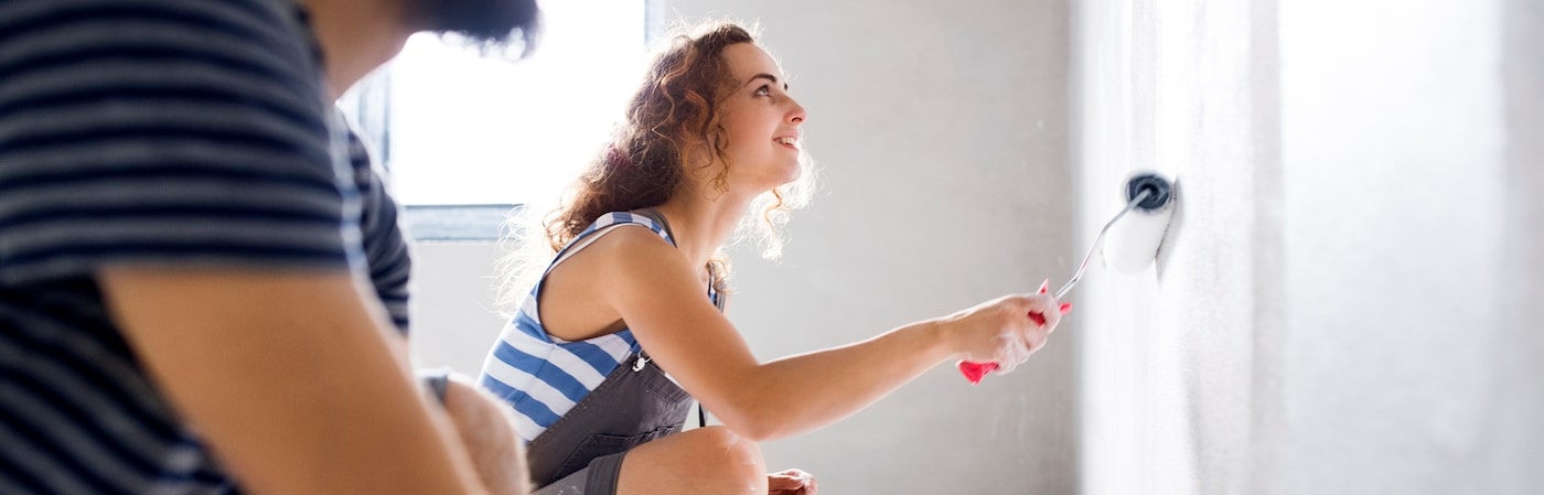 tenants repainting wall of apartment