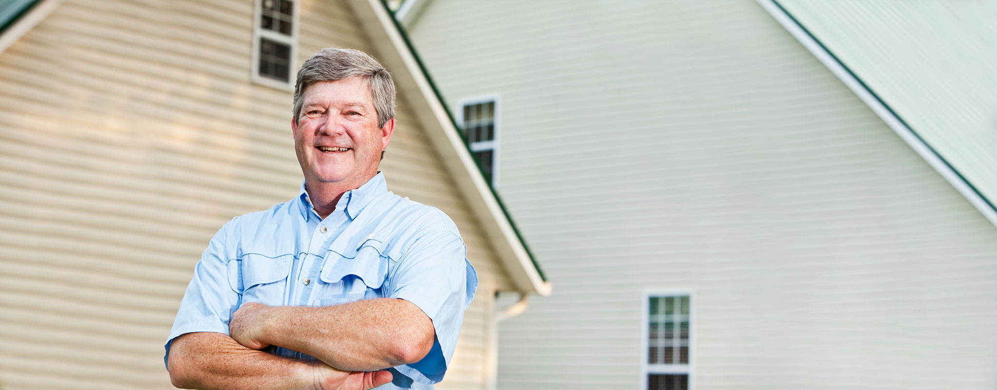 landlord standing in front of home