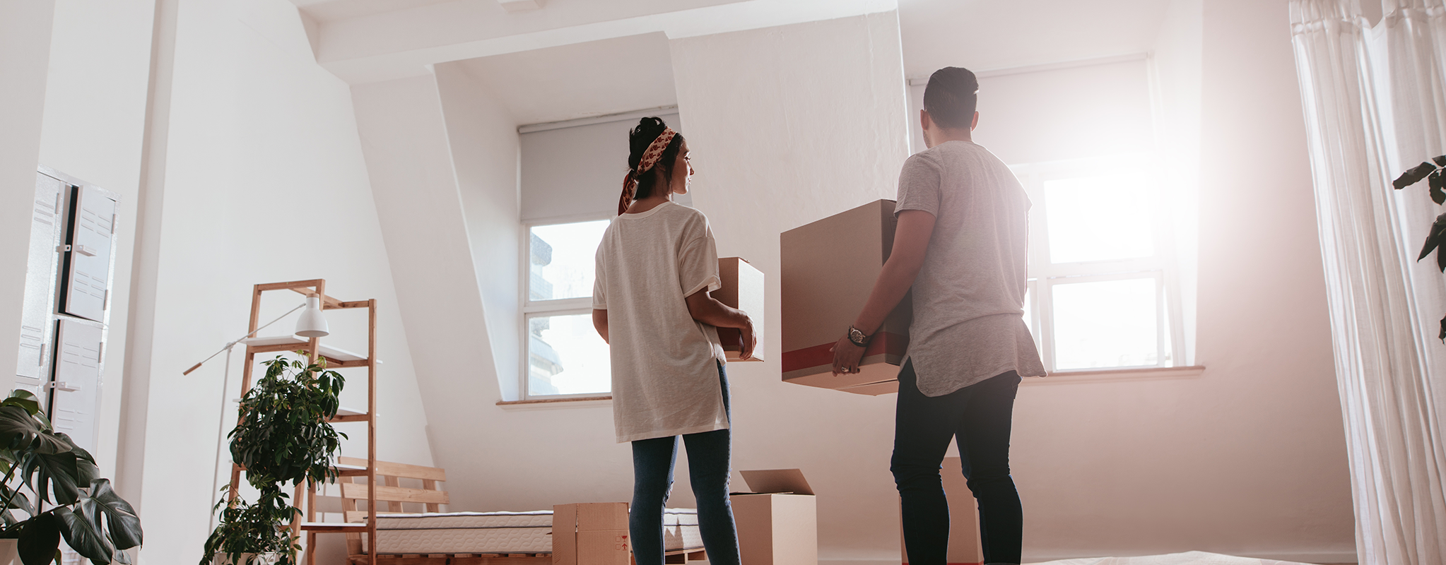 man and woman unpacking boxes in new home