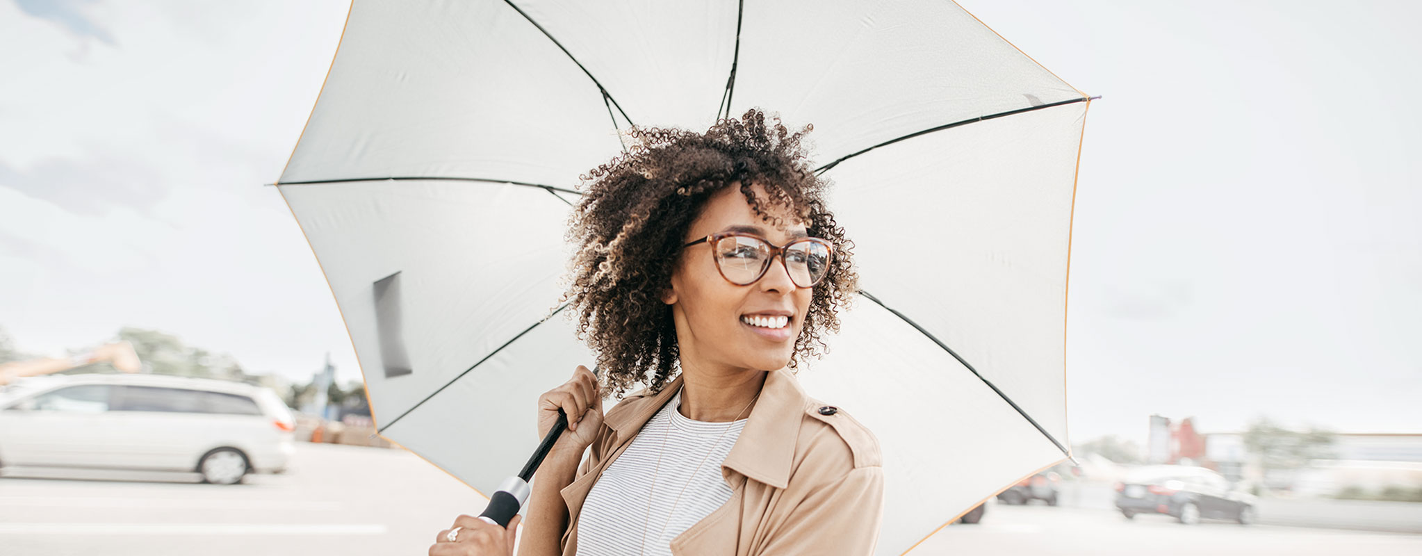woman holding umbrella smiling