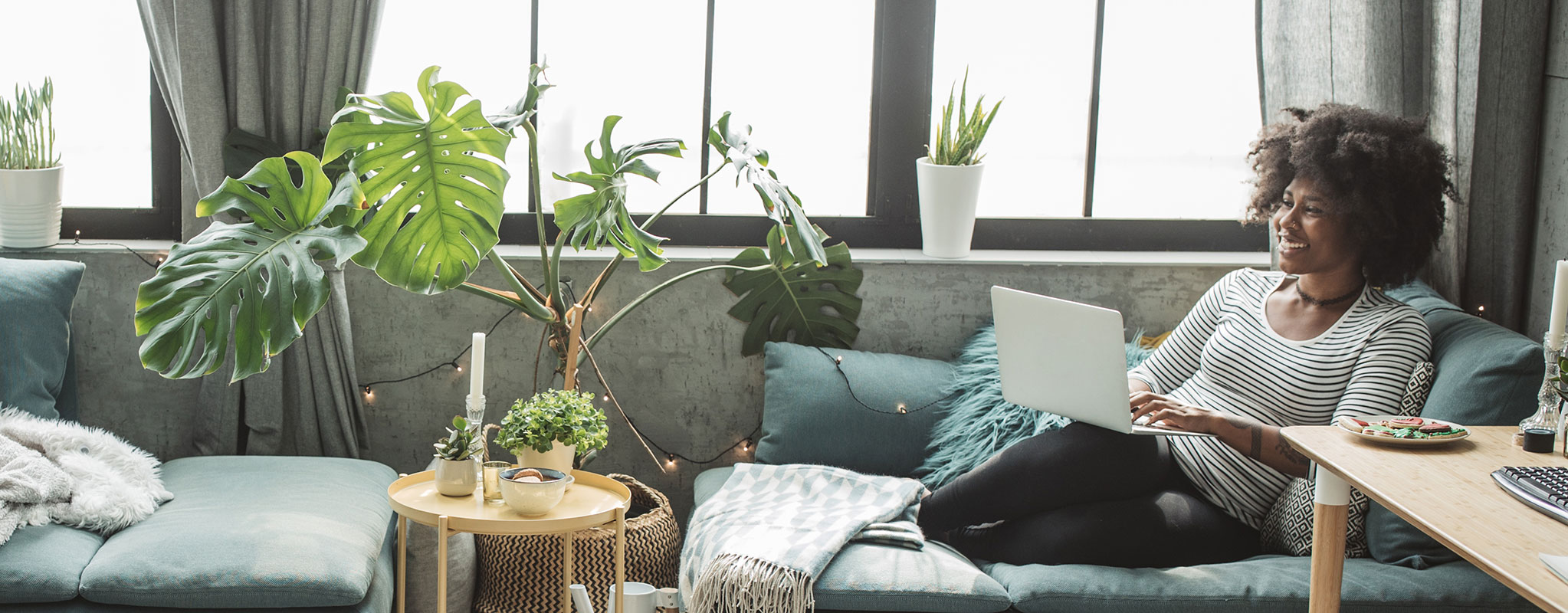 woman sitting with winter indoor plants looking happy