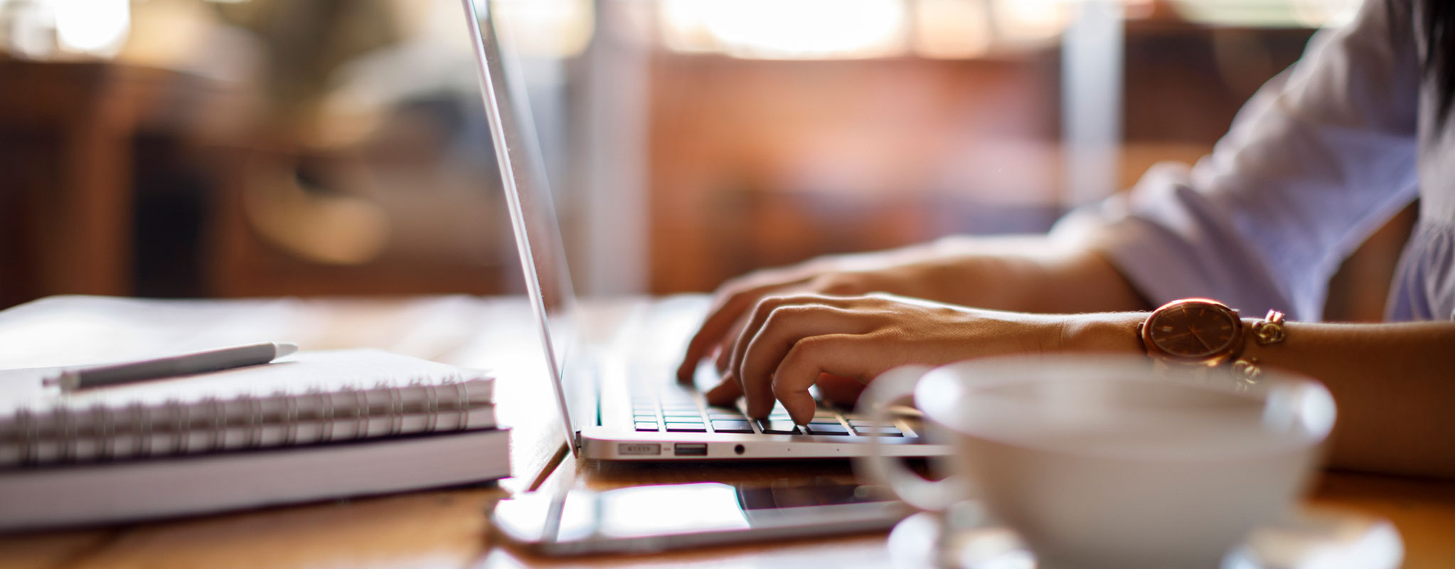 person typing on computer sitting at desk