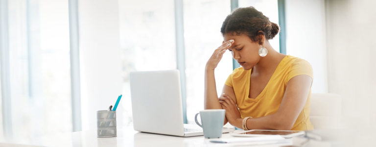 woman annoyed sitting in front of computer