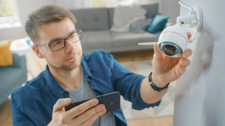 man installing security camera
