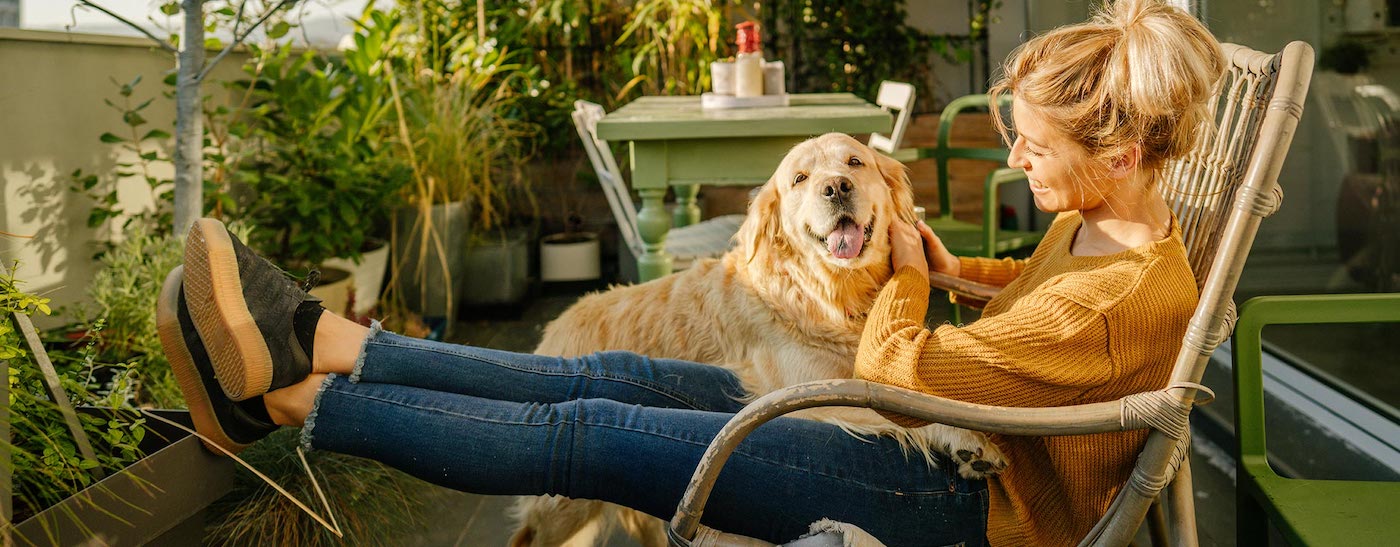 Woman on her apartment patio balcony with her dog