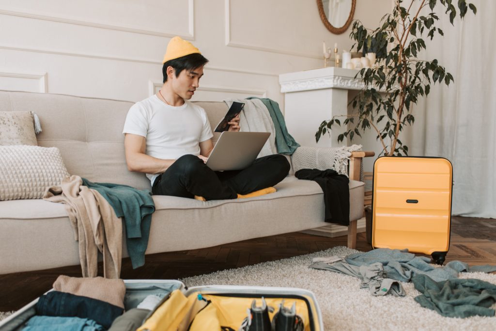 Frequent traveler with suitcase checks into his mid-term rental.