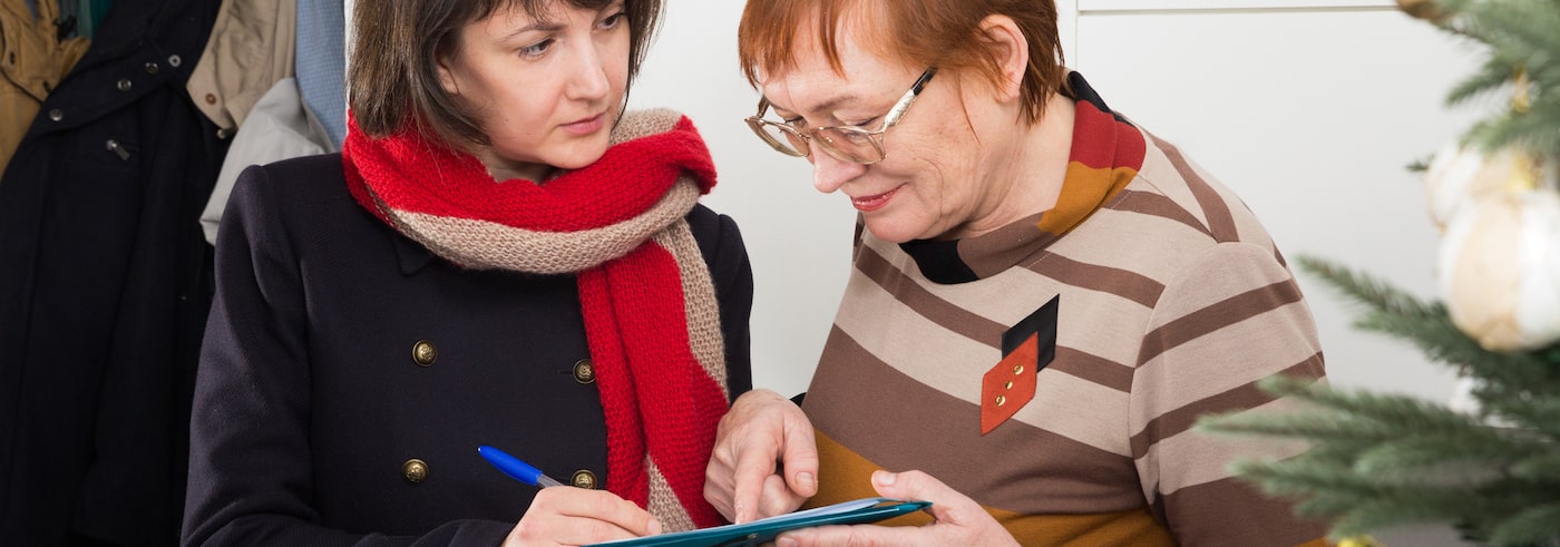 Two women going over a lease violation notice