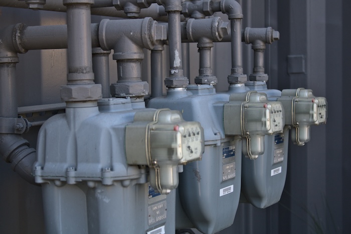 Electricity meters on the side of an apartment building