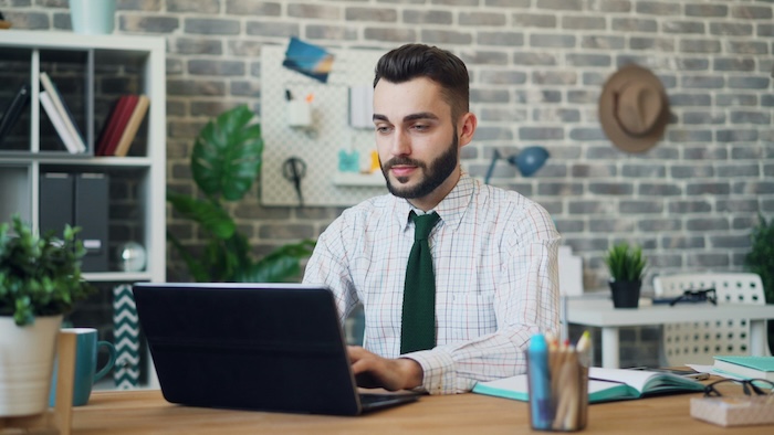 Man sitting at his computer and collecting rent
