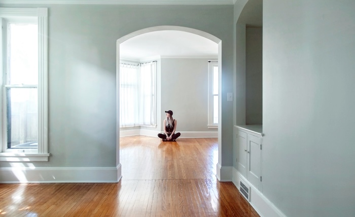 Tenant sitting in an empty apartment